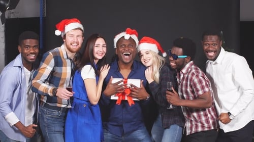 Friends Celebrating Christmas with Gift and Champagne