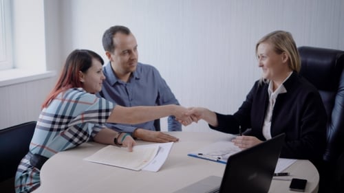 Couple Meeting with Professional, Agreeing on Deal