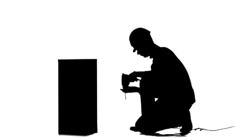 Engineer in a Helmet Works As a Drill. Silhouette. White Background
