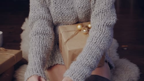 Young Woman with Gifts Near Christmas Tree