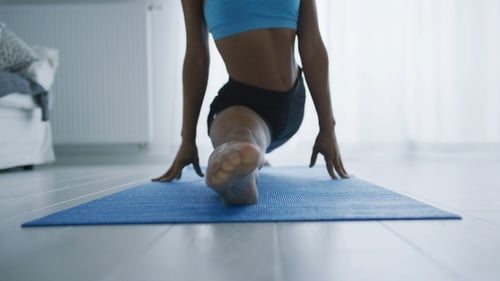 Woman Stretching Doing Splits Exercise on Yoga Mat