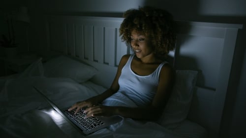 Young Woman Using Laptop in Night