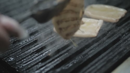 The Chef Is Cooking Squid on a Barbeque Grill