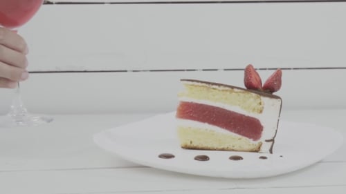 Delicious Cake with Strawberry Garnish and Red Wine