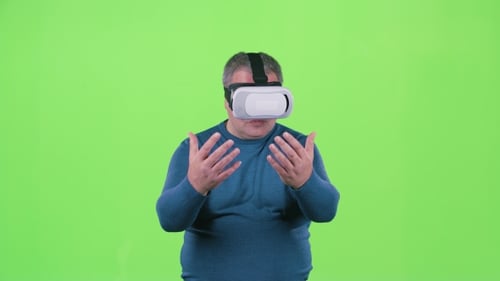 Man Is Looking at 3d Glasses. Green Screen