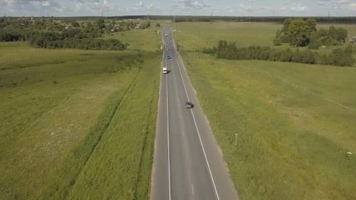 Highway Road Traffic in a Valley . Aerial Shoot of a Highway Road with Traffic Cars in a Valley with