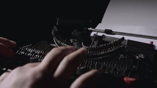 Fingers Typing on Classic Black Typewriter