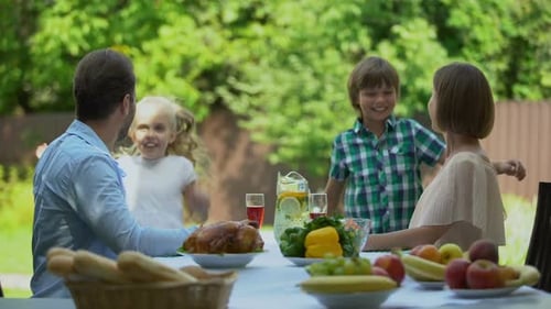 Happy Family Enjoys Outdoor Meal in Garden