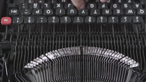 Hands Typing on Vintage Mechanical Typewriter