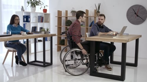 Disabled Worker and Colleagues Working in Office