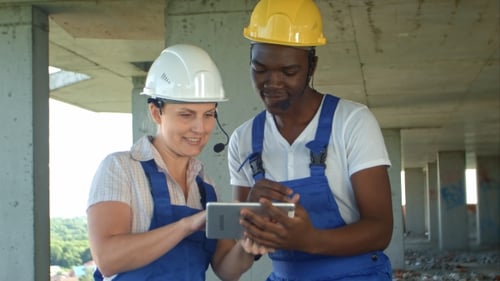Construction People Using Electronic Tablet on Site