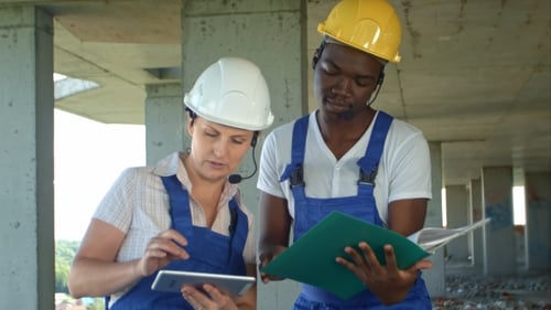 Workers Working on Building Site with Tablet