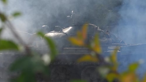 Military Tank with Smoke Moving on Battle Field