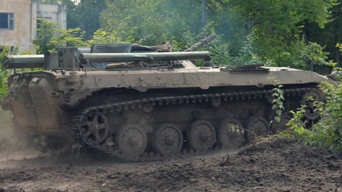 Military Tank Moving on Background Destroy Building During Hostilities