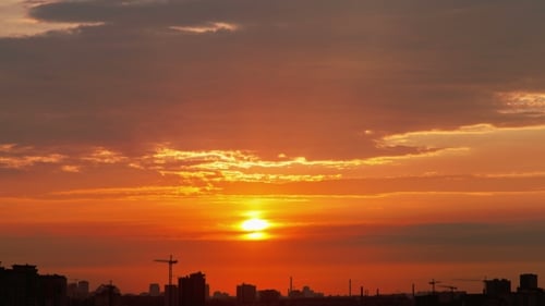 Sunset Over the Silhouettes of Buildings in the City
