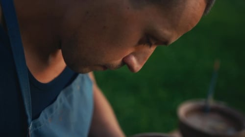 View of a Handsome Concentrated Craftsman Drawing the Decoration Via Special Tool on Just Finished