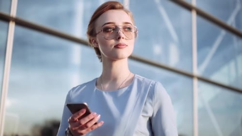 Stunning Young Business Woman in a Trendy Look and Sunglasses Stands By the Business Center, Waiting