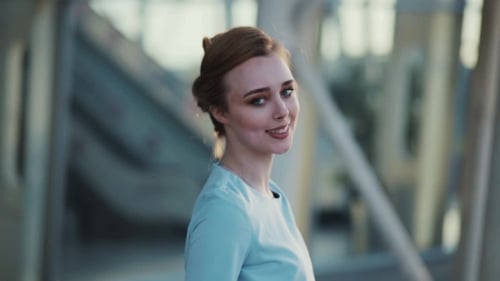 Stylish Young Woman Walks Down the Street, Turns To Camera, Puts of Her Sunglasses and Smiles