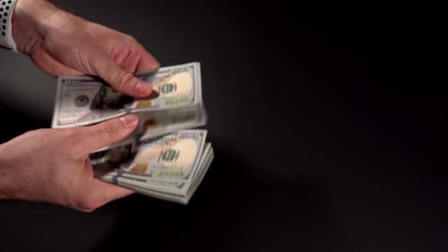 Hands Counting and Exchanging US Hundred Dollar Bills