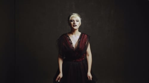 Elegant Woman Posing in Black and Red Dress