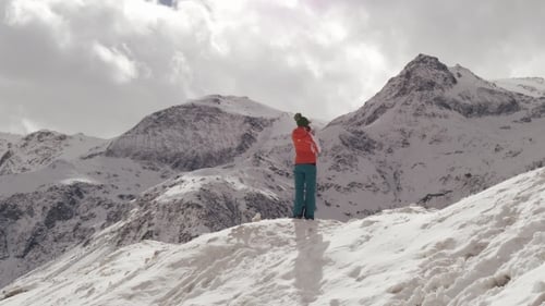 Woman enjoying view of snow covered mountains