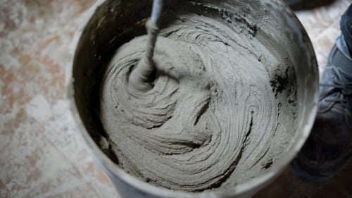 Mixing Concrete in Bucket with Drill Attachment