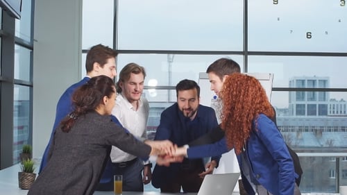 Excited Business Team Cheers Together in Modern Office