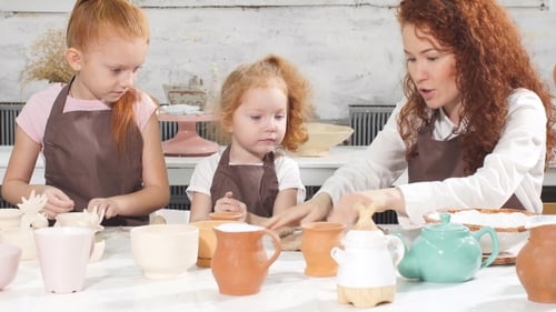 Teacher Helps the Kid To Cut Out a Clay Figurine With Spatula or Knife, Shows and Explanes