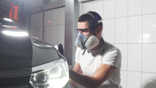 Master Polishes the Car in a Car Workshop
