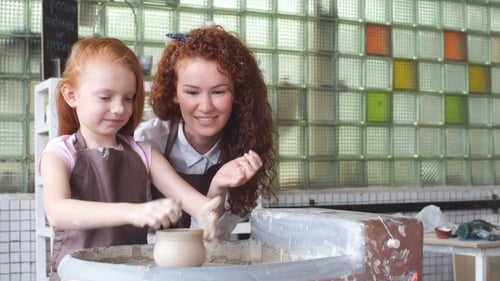 Pottery Class Workshop. Clay Shaping on Potter's Wheel. Potter Teaches His Craft To the Children.