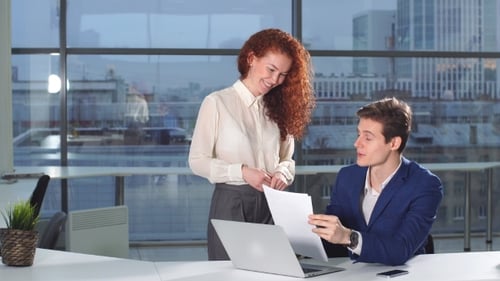 Business Colleagues Discussing Documents in Modern Office