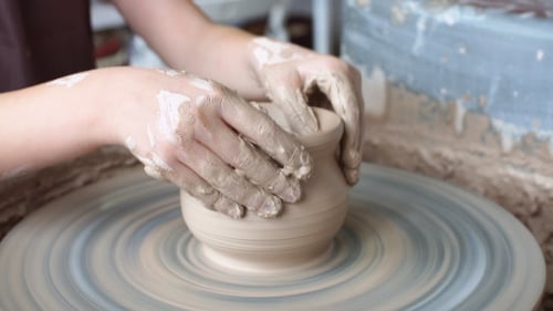 Hands Shaping Clay on Pottery Wheel