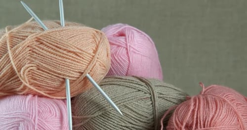 Colorful Yarn Balls with Knitting Needles Close Up
