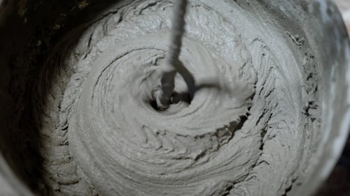 Mixing Cement Compound in Bucket Close Up