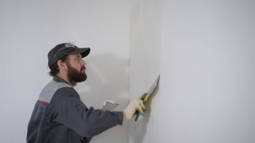 Construction Worker Plastering Wall Corner Indoors