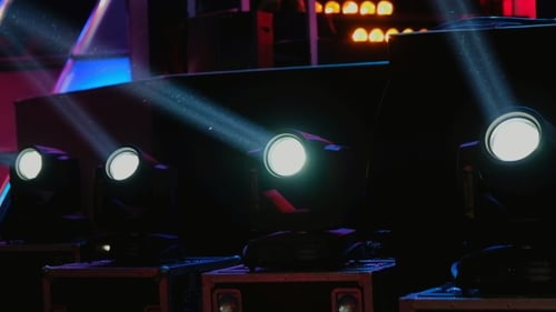 Several Stage Lights Shimmering on a Dark Stage
