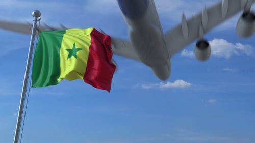 Waving Senegal Flag and Passing Commercial Airplane