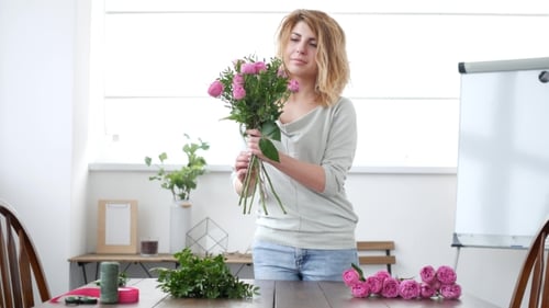 Young Woman Arranging Roses in a Bouquet
