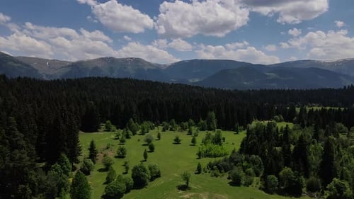 Aerial View of Green Valley and Forested Mountains