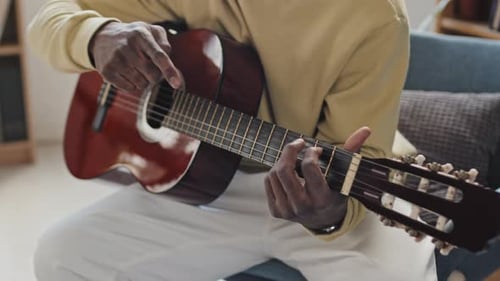Guitar Playing Close Up in a Bright Room