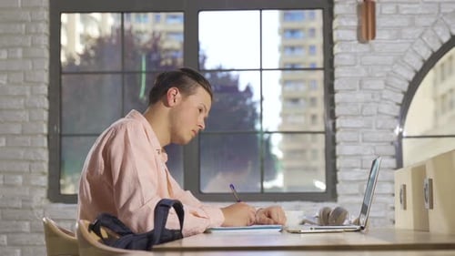 College student studying in modern library.