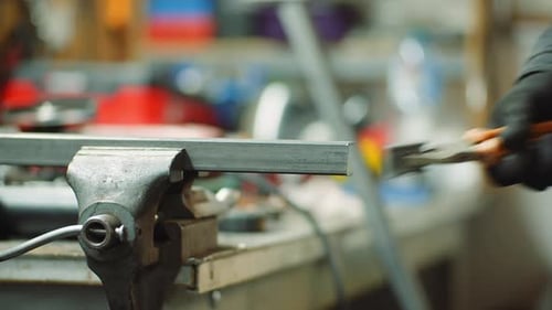 Man Working at Metal Industry - Cutting and Measuring Metal Parts at Workshop