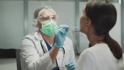 Medical Professional Administers Nasal Swab Test to Patient