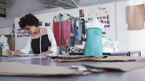 Mixed race woman working in fashion office
