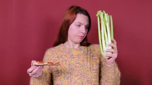 Woman Contemplating Pizza or Celery