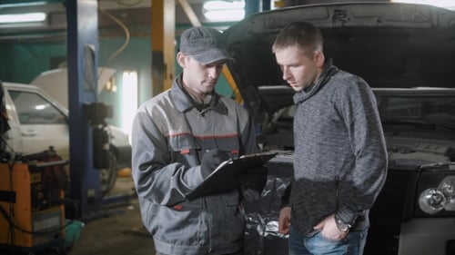 Mechanic and a Man Discussing the Cost of Car Service