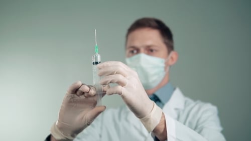 Doctor Preparing Injection in Lab Wearing Mask