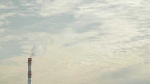 Smoking Chimneys of a Power Plant Polluting the Air