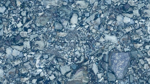 Seamless Looping Clear Water Flowing Over River Rocks Background