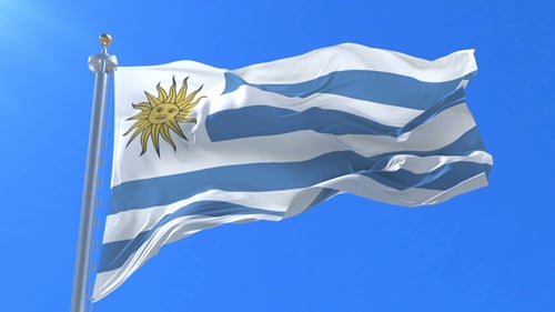 Uruguay Flag Waving in the Wind Against Blue Sky